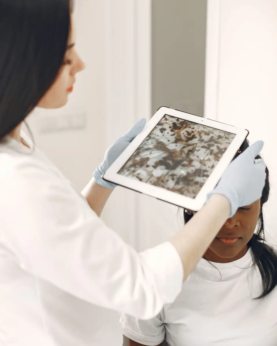 Illustrative photo of a specialist checking skin, not Ria and not a Mystique client