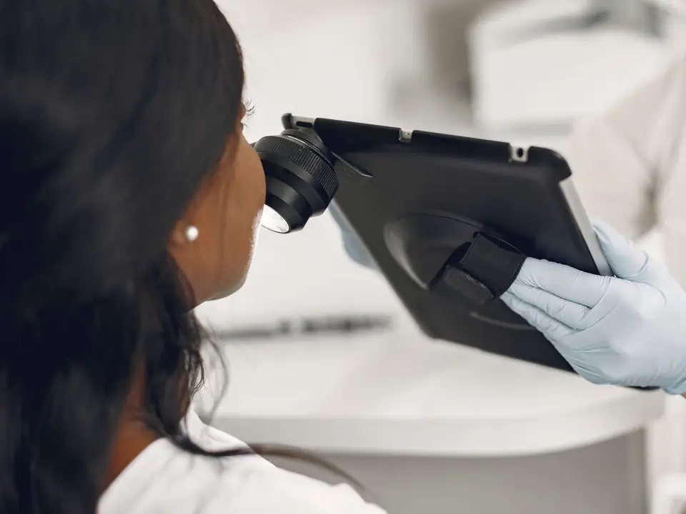 Illustrative photo of a skin consultation on a tablet, not Ria and not a Mystique client